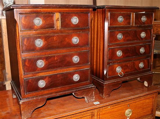 A pair of miniature chest of drawers H.54cm